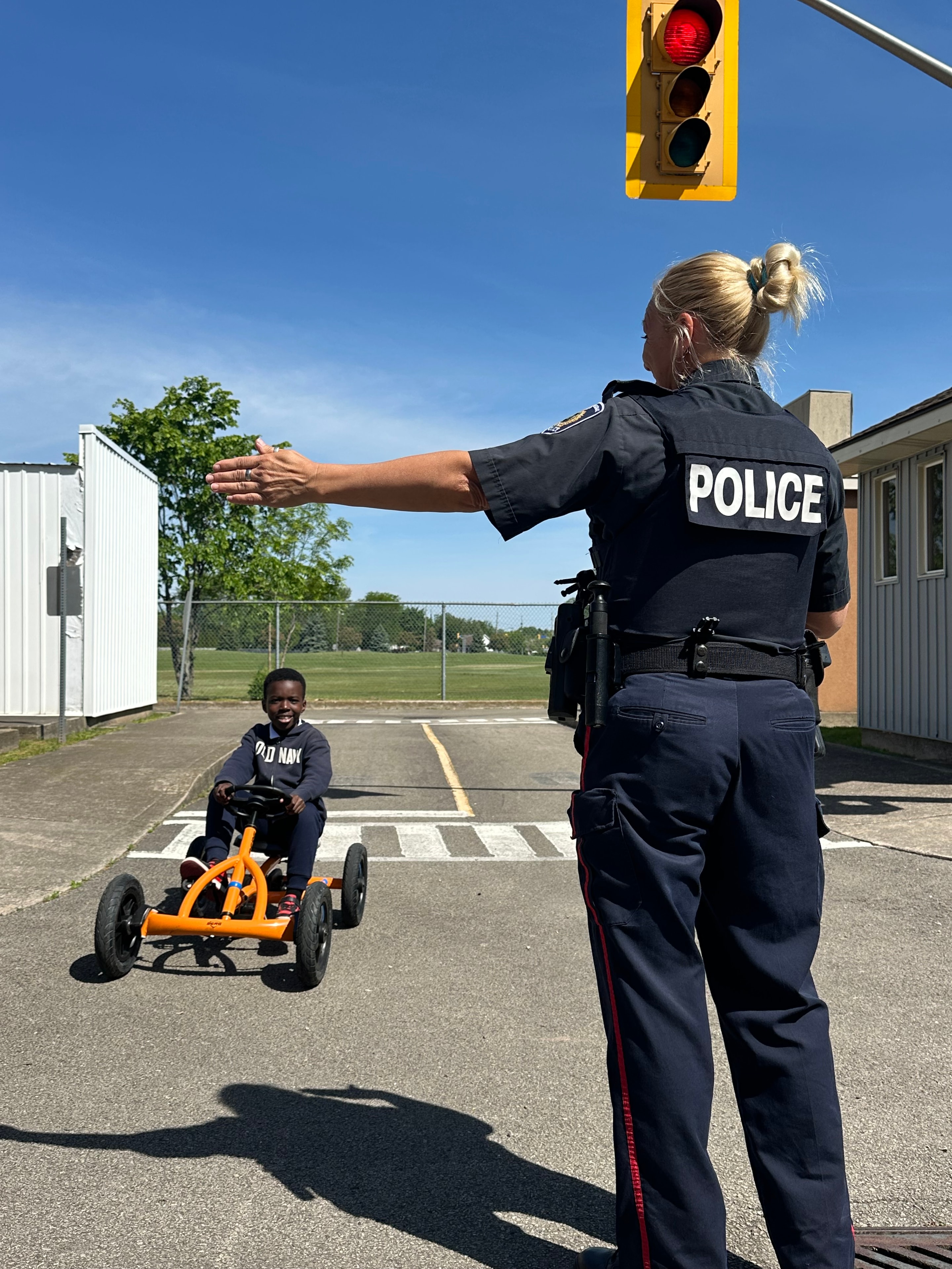 Child learning pedestrian road safety at a crosswalk