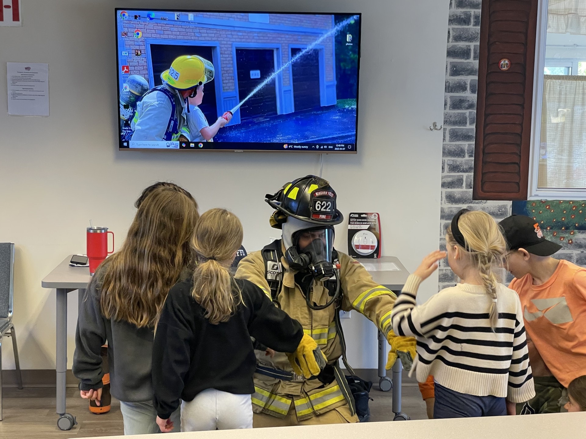 Firefighter teaching a student about fire safety