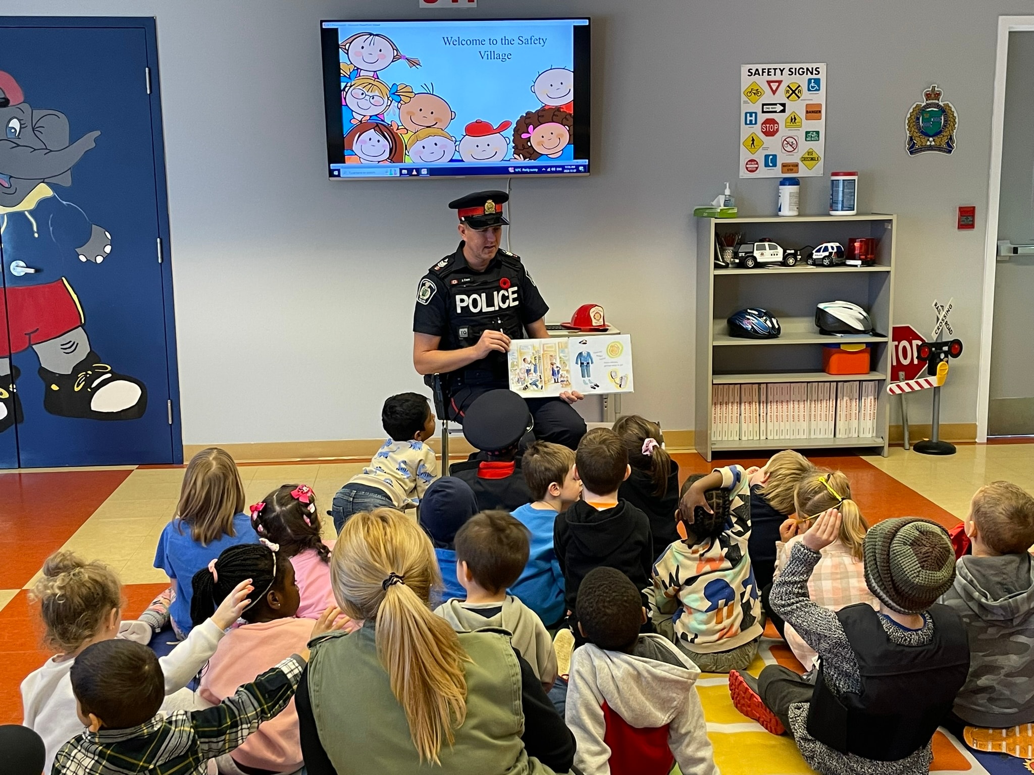 Police officer engaging with school children